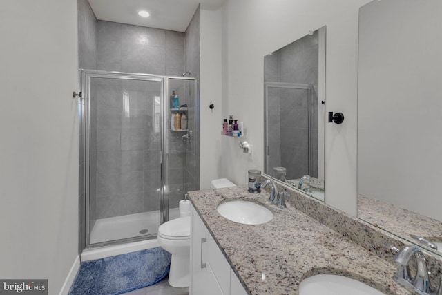 bathroom with vanity, toilet, tile patterned flooring, and a stall shower