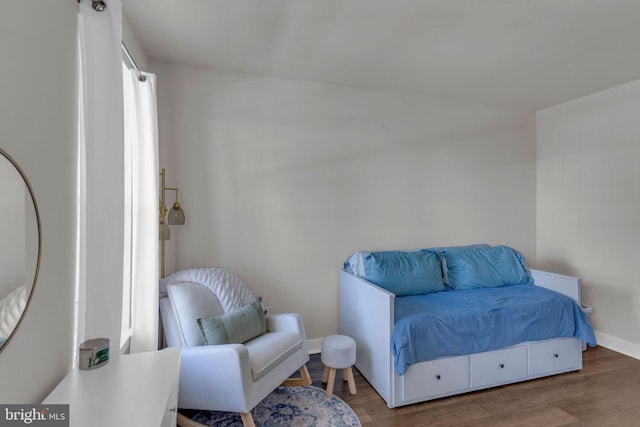 bedroom featuring baseboards and wood finished floors
