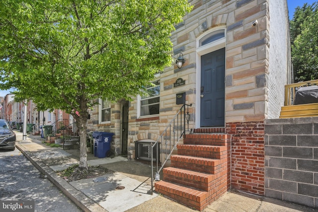 entrance to property featuring stone siding