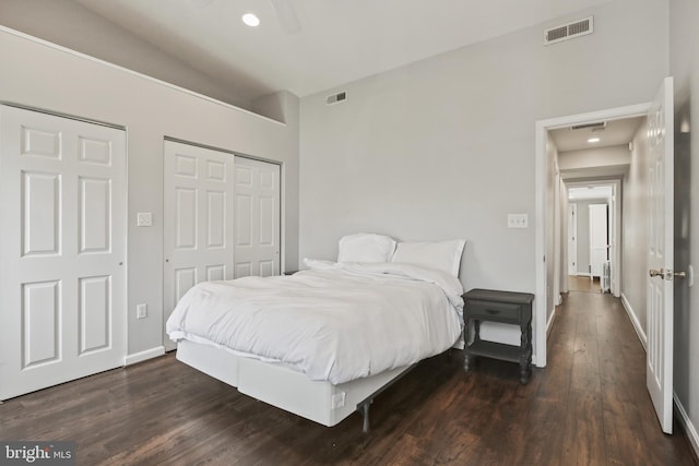 bedroom featuring visible vents, dark wood-style flooring, baseboards, and a closet