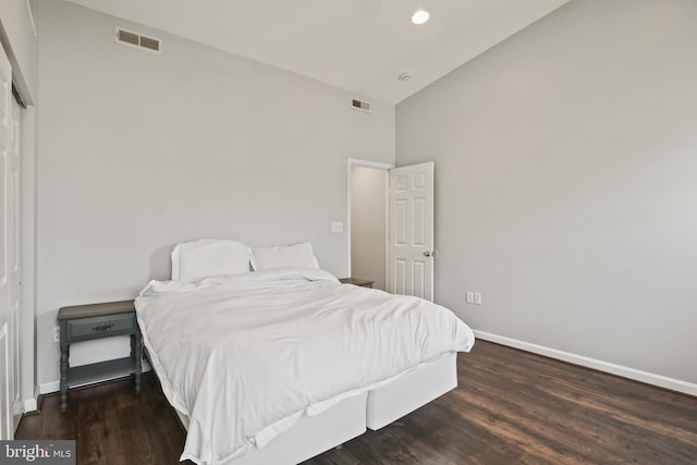 bedroom with visible vents, baseboards, and high vaulted ceiling
