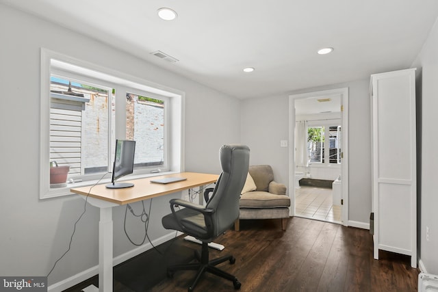 office featuring dark wood-style flooring, baseboards, visible vents, and recessed lighting