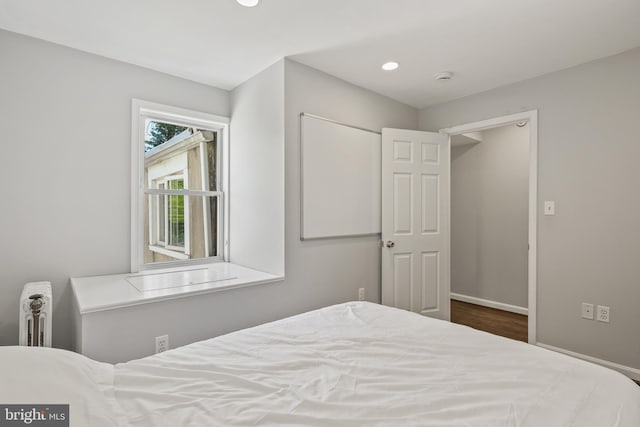 bedroom featuring baseboards, recessed lighting, and wood finished floors