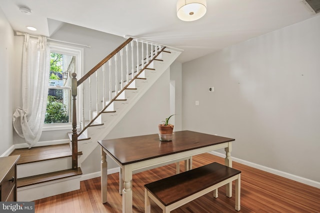 interior space featuring baseboards, wood finished floors, and visible vents