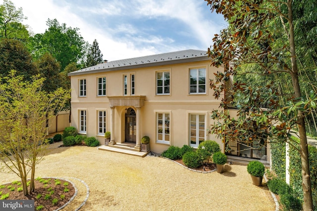 2740 Chain Bridge Rd NW, Washington, DC 20016 - view of front of house featuring stucco siding and gravel driveway