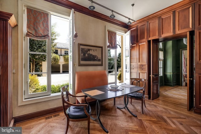 2740 Chain Bridge Rd NW, Washington, DC 20016 - dining space featuring baseboards, ornamental molding, visible vents, and track lighting