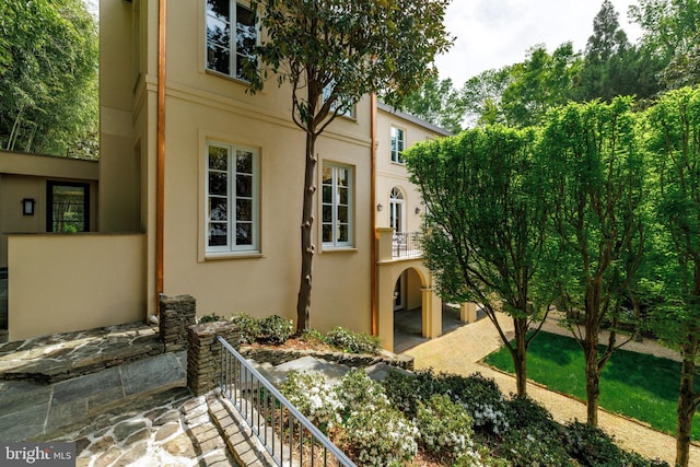 2740 Chain Bridge Rd NW, Washington, DC 20016 - view of side of home featuring stucco siding and stairs