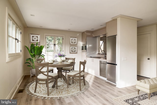 2740 Chain Bridge Rd NW, Washington, DC 20016 - dining space with light wood finished floors, visible vents, and baseboards