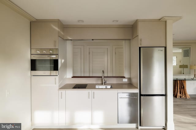 2740 Chain Bridge Rd NW, Washington, DC 20016 - kitchen featuring stainless steel appliances, light wood finished floors, visible vents, a sink, and light countertops