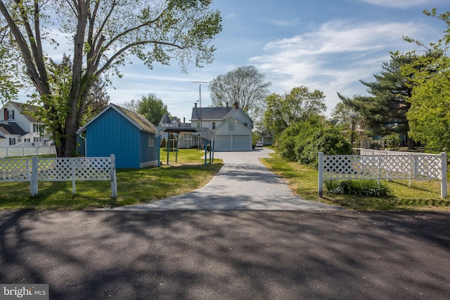 view of street with a gated entry and driveway