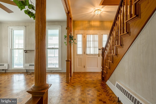 entrance foyer featuring radiator and stairs