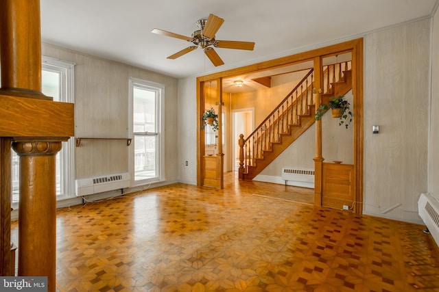 interior space featuring stairway, a ceiling fan, and a wealth of natural light