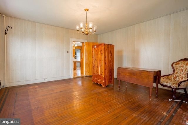 interior space featuring wood-type flooring and an inviting chandelier