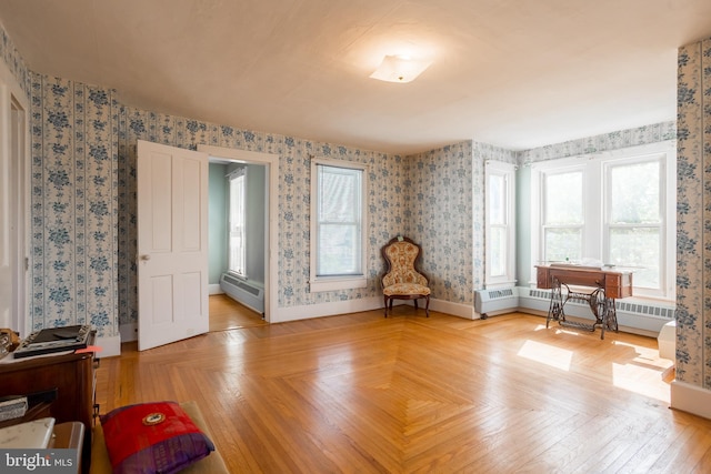 sitting room featuring wallpapered walls