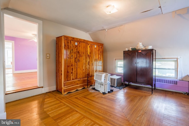 bonus room featuring radiator and vaulted ceiling