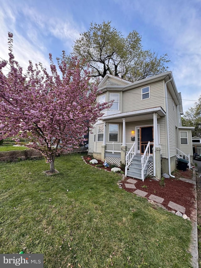 view of front of house featuring a front yard and a porch