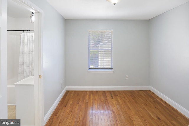 unfurnished room featuring wood finished floors and baseboards