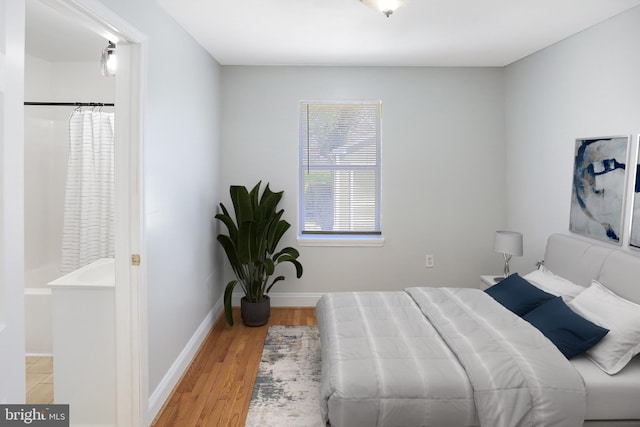 bedroom featuring baseboards and light wood-style floors