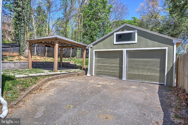 detached garage featuring fence