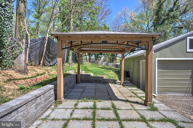 view of patio / terrace with a gazebo and a garage