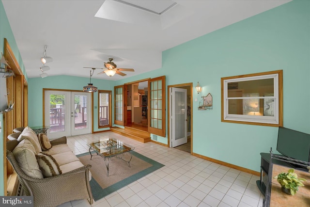 living room with french doors, baseboards, tile patterned floors, and vaulted ceiling