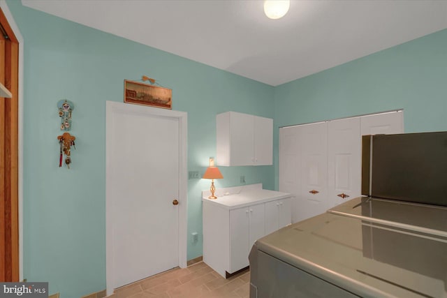 washroom featuring cabinet space and washer / dryer