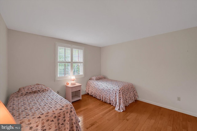 bedroom with baseboards and light wood-style flooring