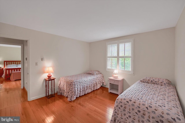 bedroom with light wood-style floors and baseboards