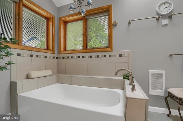 bathroom with visible vents, plenty of natural light, and a garden tub