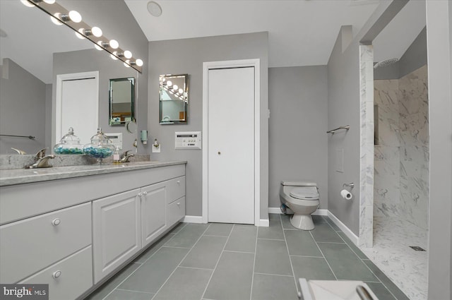 full bathroom with toilet, baseboards, walk in shower, and a sink