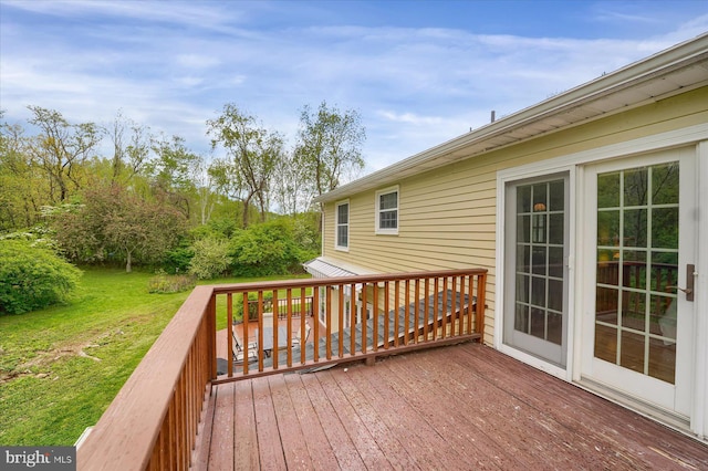 wooden terrace with a yard