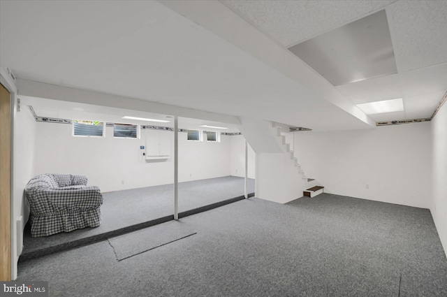 basement with carpet and stairway