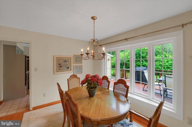 dining area with baseboards and an inviting chandelier
