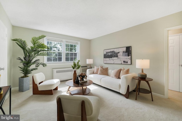 living room with radiator, baseboards, and carpet