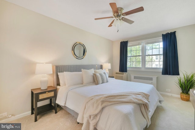 bedroom featuring carpet floors, a ceiling fan, baseboards, and radiator heating unit