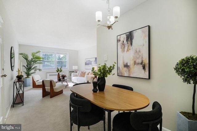 dining room with light colored carpet, baseboards, and an inviting chandelier