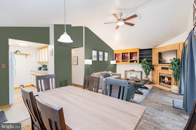 371 Oak Hill Rd, Berkeley Springs, WV 25411 - dining room featuring visible vents, a ceiling fan, baseboards, and lofted ceiling