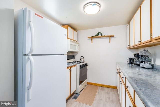371 Oak Hill Rd, Berkeley Springs, WV 25411 - kitchen with open shelves, light wood-style floors, white appliances, white cabinetry, and baseboards