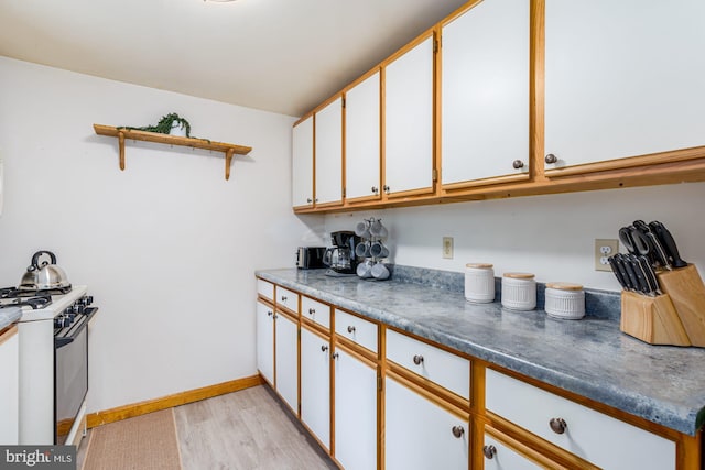 371 Oak Hill Rd, Berkeley Springs, WV 25411 - kitchen featuring white cabinets, open shelves, baseboards, and white gas range