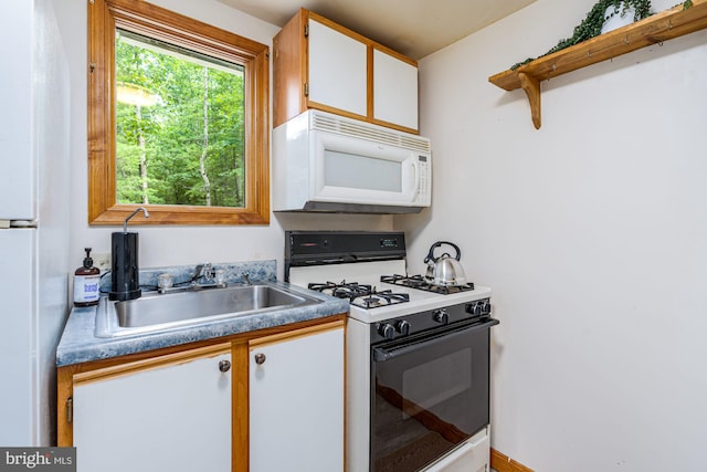 371 Oak Hill Rd, Berkeley Springs, WV 25411 - kitchen featuring a sink, open shelves, white appliances, and white cabinetry