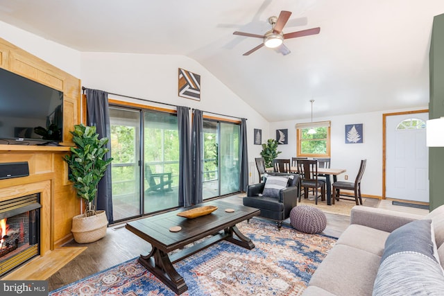371 Oak Hill Rd, Berkeley Springs, WV 25411 - living area featuring a ceiling fan, a warm lit fireplace, wood finished floors, and lofted ceiling