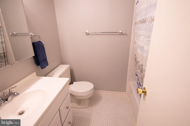 bathroom with toilet, tile patterned floors, and vanity