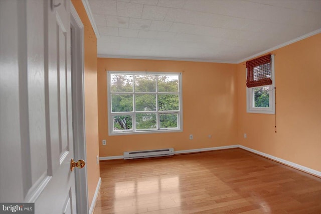 125 Cottage St, Waynesboro, PA 17268 - empty room with baseboard heating, wood finished floors, crown molding, healthy amount of natural light, and baseboards