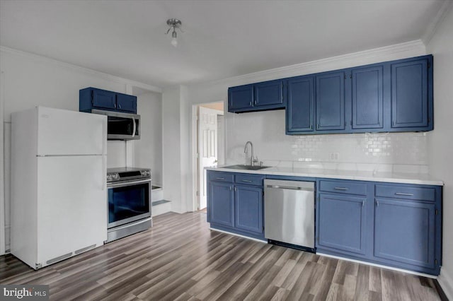 125 Cottage St, Waynesboro, PA 17268 - kitchen with appliances with stainless steel finishes, blue cabinets, a sink, and ornamental molding