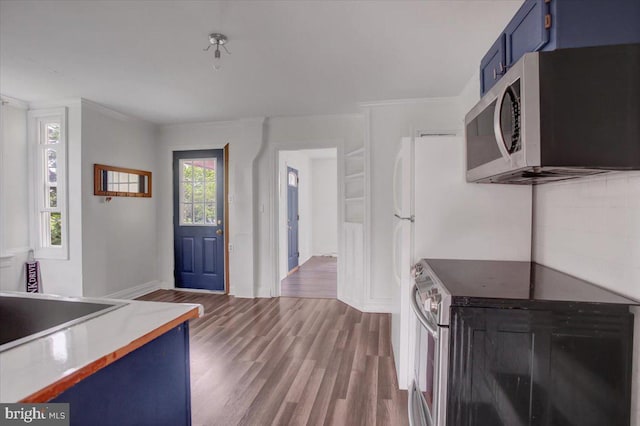 125 Cottage St, Waynesboro, PA 17268 - kitchen with blue cabinets, appliances with stainless steel finishes, wood finished floors, crown molding, and baseboards