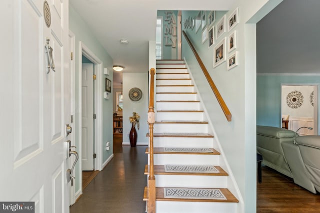 stairs featuring baseboards and wood finished floors