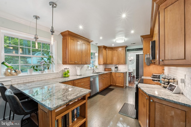 kitchen featuring a sink, appliances with stainless steel finishes, backsplash, and a peninsula