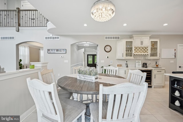 3357 Huntingdon Pike, Huntingdon Valley, PA 19006 - dining space with beverage cooler, arched walkways, a chandelier, bar, and light tile patterned floors