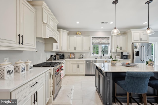 3357 Huntingdon Pike, Huntingdon Valley, PA 19006 - kitchen featuring appliances with stainless steel finishes, a breakfast bar, a sink, light tile patterned floors, and hanging light fixtures