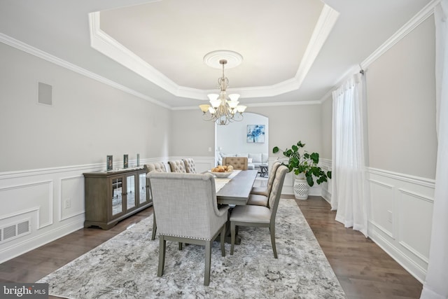 3357 Huntingdon Pike, Huntingdon Valley, PA 19006 - dining room with a tray ceiling, a chandelier, dark wood-style flooring, crown molding, and a decorative wall
